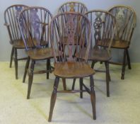 Six 19th century elm seated wheel back chairs, including two with arms Each of typical form,