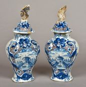 A pair of 18th/19th century Dutch Delft vases and covers Each decorated in blue,