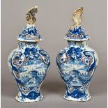 A pair of 18th/19th century Dutch Delft vases and covers Each decorated in blue,