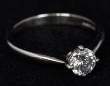 A diamond set platinum solitaire ring The claw set stone approximately 0.68 carat.