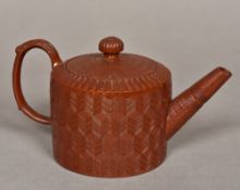 An 18th century English glazed engine turned Redware teapot With acanthus capped scroll handle,