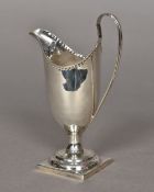 A George III silver cream jug, hallmarked London 1788,