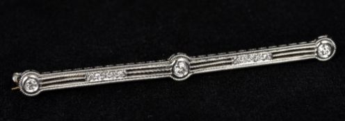 An Art Deco platinum and diamond set bar brooch 6.25 cm long.