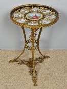 A 19th century Sevres porcelain topped gilt bronze table The circular top centred with a portrait