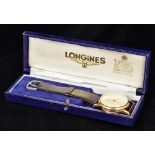 A 9 ct gold Longines gentleman's wristwatch The white dial with Arabic numerals and batons,