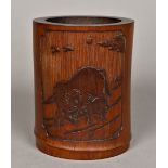 A Chinese carved bamboo brush pot Worked with a buffalo and calf opposing calligraphic script.