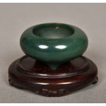 A Chinese carved hardstone censor Of diminutive form, standing on a carved wood base.