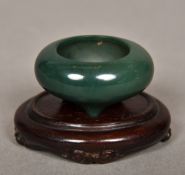 A Chinese carved hardstone censor Of diminutive form, standing on a carved wood base.