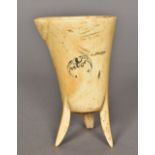 A Chinese carved bone jue Of typical three-legged form, carved with a bat and a flaming pearl.