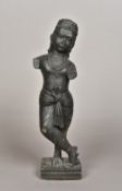 An Indian carved black hardstone model of Krishna Modelled standing wearing a headdress and