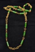An 18 ct gold and apple green jade necklace The clasp stamped 18K and Italy. 85 cm long.