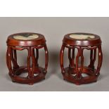 A pair of carved and pierced Chinese hardwood and hardstone inset table top urn stands Of barrel