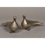 A pair of Iranian silver bird figures Naturalistically modelled with turquoise eyes. 11 cm high.