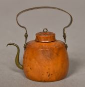 A 19th century miniature teapot Carved from a coquilla nut with brass fittings. 4.25 cm wide.