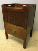 A George III mahogany bedside commode The three quartered galleried top above a tambour fronted