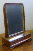 A George III mahogany toilet mirror The bevelled mirror plate housed in a parcel gilt and moulded