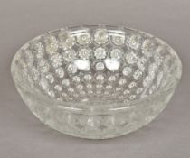 An Art Deco clear glass bowl Decorated in the round with impressed rosettes. 25.5 cm diameter.