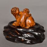 A late 19th century Chinese carved boxwood animalier group Formed as a dog with a puppy,
