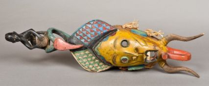 A Guro carved wood and polychrome decorated mask The slender scarified face surmounted with the