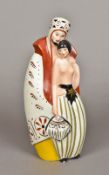 An Art Deco Limoges porcelain lamp Formed as a cloaked bearded figure and a semi-nude lady holding