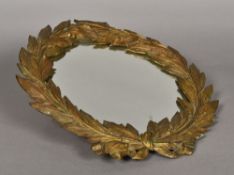 A 19th century gilt bronze wall glass Formed as a laurel wreath. 40 cm wide.