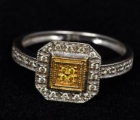 An Art Deco white gold diamond set ring Of canted square form, with diamond set shoulders.