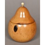 A fruitwood tea caddy modelled as a pear The hinged lid with a turned bone mounted finial. 14.