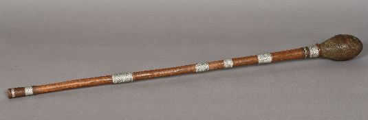 An African tribal club With knopped finial and elongated stem and decorated with bi-colour wirework