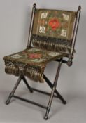 A 19th century Turkish folding chair With painted and stitched decorations. 44 cm wide.