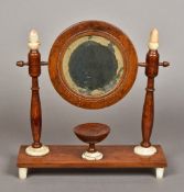 A 19th century Continental shaving mirror The circular mirror plate supported on turned wooden