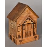 A specimen wood money box Worked as a cottage. 18.5 cm high.