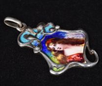 An Art Nouveau unmarked silver and enamel pendant Of scrolling stylised form,