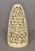 A 19th century Indian pierced ivory tusk carving Centred with a deity in a scrolling pierced cage.