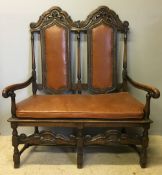 A 19th century 17th century style double chair back settee With twin scroll carved top rail above