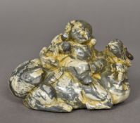 A Chinese carved green and cream banded chalcedony group Worked as Daikoku seated on a recumbent