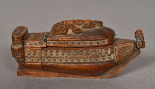 An 18th century carved coquilla nut snuff box Formed as a ship, the hinged lid carved with cupid.