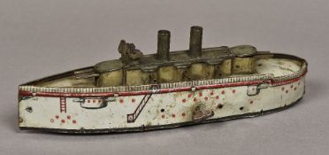 An early 20th century clockwork tinplate model of an iron clad battleship Of typical form.