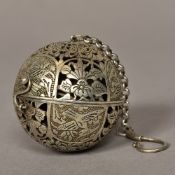 A Chinese white metal travelling censor Of hinged spherical form with pierced decoration.