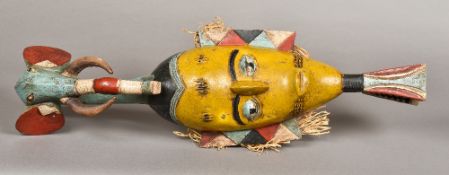 A Guro carved wood and polychrome decorated mask The slender scarified face surmounted with a