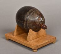 A 19th century carved coconut bugbear Of typical form, one end carved with a face,