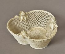 A Belleek porcelain basket Of heart shaped form, decorated with roses,