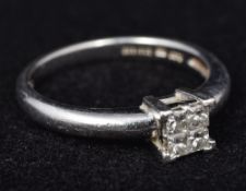 A platinum and diamond four stone ring The four centrally claw set stones totalling approximately 0.