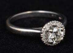 An 18 ct white gold diamond set target ring The central stone spreading to approximately 0.5 carat.