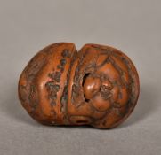 A Japanese carved wood netsuke Worked a