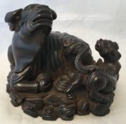 A Chinese carved hardwood group Worked