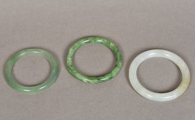 Three Chinese carved jade bangles The l