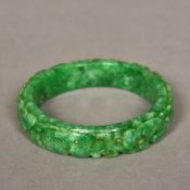 A Chinese carved mottled green jade bang