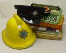 A quantity of children's annuals, Fairy Lights, a tin plate typewriter, fireman's helmet, etc.