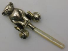 A silver teddy bear rattle