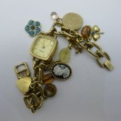 A lady's Fossil charm bracelet watch